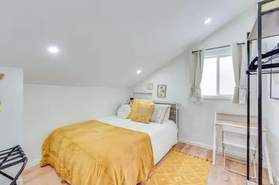 a bedroom with a bed with a yellow blanket at Dog-Friendly Fishkill Tiny House in Wine Country in Fishkill