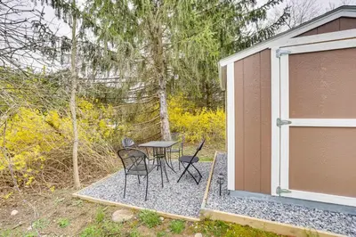 a patio with a table and chairs next to a building at Dog-Friendly Fishkill Tiny House in Wine Country in Fishkill