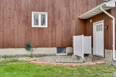 a house with a white door and a window at Dog-Friendly Fishkill Tiny House in Wine Country in Fishkill