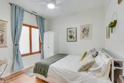 a white bedroom with a bed and a window at Dog-Friendly Fishkill Tiny House in Wine Country in Fishkill