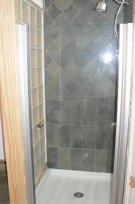 a shower with a glass door in a bathroom at Where Memories Are Made in West Kill