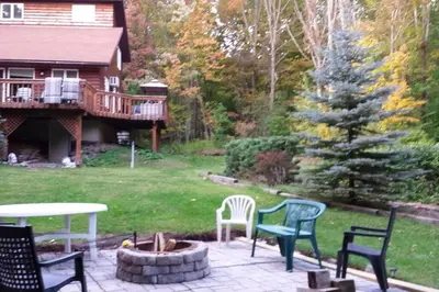 a patio with chairs and a fire pit and a house at Where Memories Are Made in West Kill
