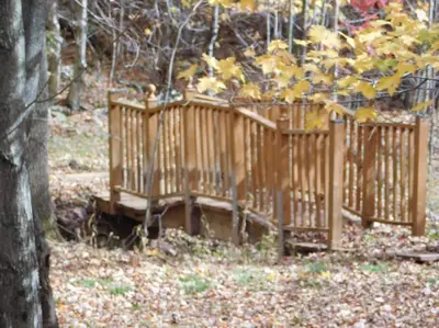 a wooden fence in the middle of a forest at Where Memories Are Made in West Kill