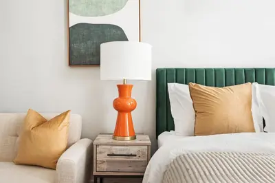 a bedroom with a bed and a table with a lamp at 73-819 New Studio UWS Doorman Gym in New York