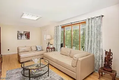 a living room with a couch and a table at Large Private House on 5 Wooded Acres. Total Privacy! in Hackettstown