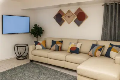 a living room with a couch and a screen at Serenity Cove -2 Bedroom Apartment in Newark