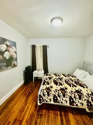 a bedroom with a cow blanket on a bed at fearlessrose vacation Rental 198 in Springfield