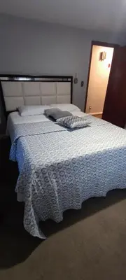 a bedroom with a large bed with a white comforter at Picon Homey in Springfield