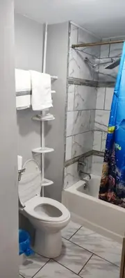 a bathroom with a toilet and a bath tub at Picon Homey in Springfield
