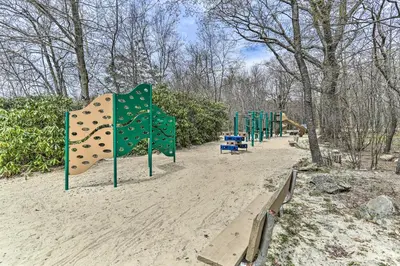 a row of playground equipment in a park at Lovely Tobyhanna Getaway with Game Room and Fire Pit! in Tobyhanna
