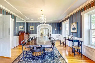 a dining room with a long table and chairs at Group Getaway on Working Farm! Near Saratoga in Ballston Lake