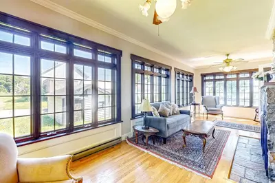 a living room filled with furniture and windows at Group Getaway on Working Farm! Near Saratoga in Ballston Lake