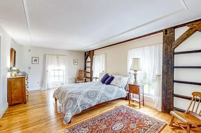 a bedroom with a bed and a large window at Group Getaway on Working Farm! Near Saratoga in Ballston Lake