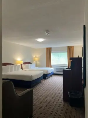 a hotel room with two beds and a window at River Valley Inn in Hatfield
