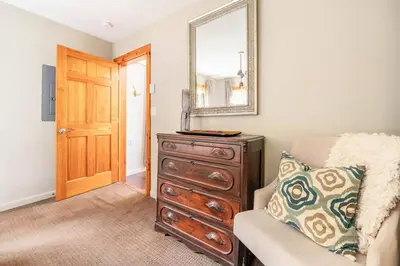 a living room with a dresser and a mirror at Serene Retreat on a Stream in Phoenicia