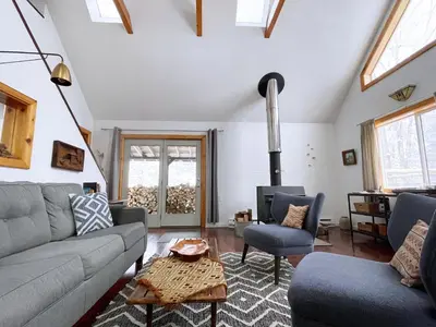 a living room with a couch and a table at Serene Retreat on a Stream in Phoenicia