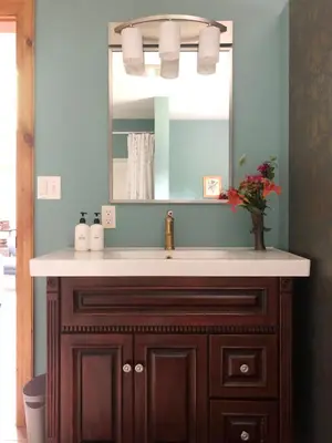 a bathroom with a sink and a mirror at Serene Retreat on a Stream in Phoenicia