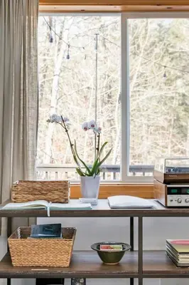 a table with a window and a vase with flowers at Serene Retreat on a Stream in Phoenicia