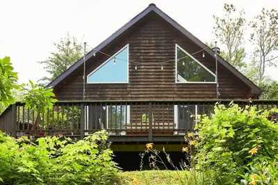 a house with a large window on the front of it at Serene Retreat on a Stream in Phoenicia