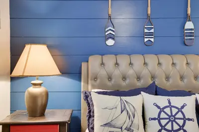 a blue bedroom with a bed with a blue wall at 2BR Cottage with Hot Tub in Tobyhanna