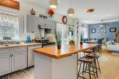 a kitchen with white cabinets and a wooden counter top at 6 Mi to Mt Snow Nature-View Home with Fire Pit! in West Dover