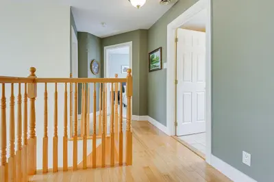 a staircase in a home with green walls at 6 Mi to Mt Snow Nature-View Home with Fire Pit! in West Dover