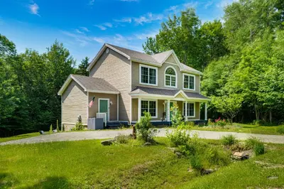 a house with a green door on a driveway at 6 Mi to Mt Snow Nature-View Home with Fire Pit! in West Dover