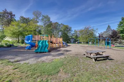 a playground with a blue slide and a bench at Spacious Retreat 7 Mi to Tobyhanna State Park! in Tobyhanna