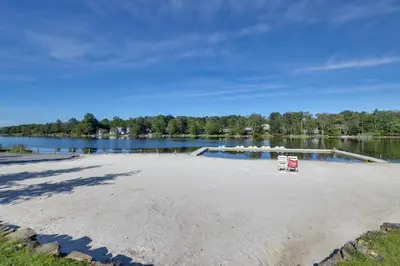 a sandy beach next to a body of water at Spacious Retreat 7 Mi to Tobyhanna State Park! in Tobyhanna
