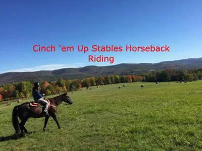 a person riding a horse in a field at Berkshires Studio Apartment at the Stephentown Hotel in Hancock