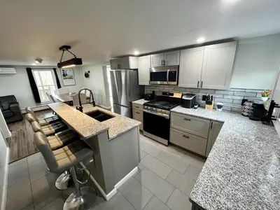 a large kitchen with a sink and a stove at The entire Stephentown Hotel. 28 person occupancy in Hancock