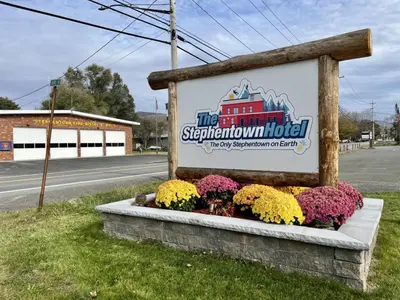 a sign for the springmont hotel with flowers at The entire Stephentown Hotel. 28 person occupancy in Hancock