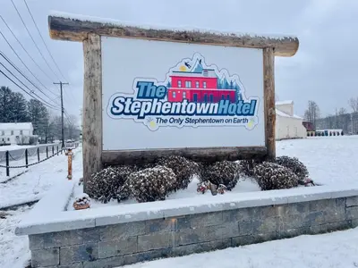 a sign for the stophamatown hotel in the snow at The entire Stephentown Hotel. 28 person occupancy in Hancock