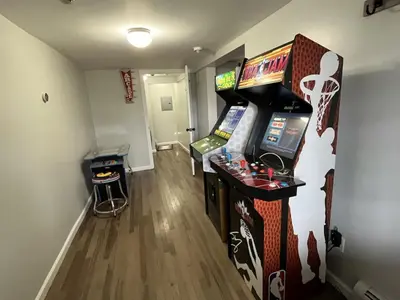 a room with a video game console and a arcade at The entire Stephentown Hotel. 28 person occupancy in Hancock