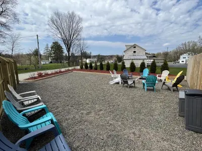a group of chairs and tables in a yard at The entire Stephentown Hotel. 28 person occupancy in Hancock