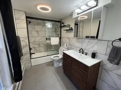 a bathroom with a shower and a sink and a toilet at The entire Stephentown Hotel. 28 person occupancy in Hancock