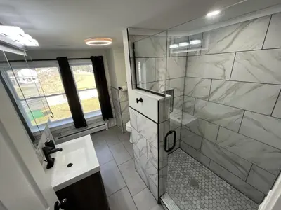 a bathroom with a shower and a sink at The entire Stephentown Hotel. 28 person occupancy in Hancock