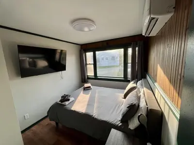 a small bedroom with a bed and a window at 2 Bed Berkshire Getaway minutes to Jiminy Peak Ski in Hancock