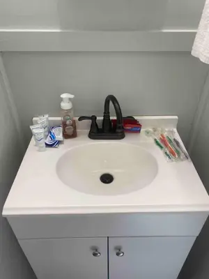 a white bathroom sink with a black faucet on it at 2 Bed Berkshire Getaway minutes to Jiminy Peak Ski in Hancock