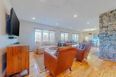 a living room with a couch and a tv and a fireplace at Alpine Abode in Dover