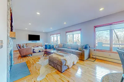 a living room with a couch and a tv at Alpine Abode in Dover