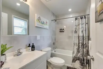 a bathroom with a toilet and a sink and a tub at Modern City Getaway Near Downtown Newark & NYC in Newark