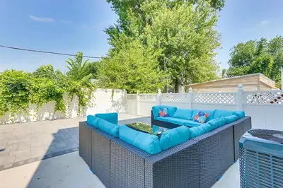 a blue couch sitting on top of a patio at Modern City Getaway Near Downtown Newark & NYC in Newark