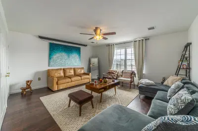 a living room with a couch and a table at Huge 3BR Urban Gem just 3 miles to NYC plus Free Parking in Jersey City