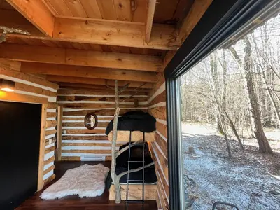 a inside view of a log cabin with a window at Casa Del Rio in Margaretville