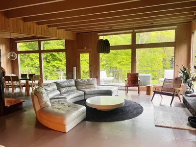 a living room with a couch and a table at Casa Del Rio in Margaretville