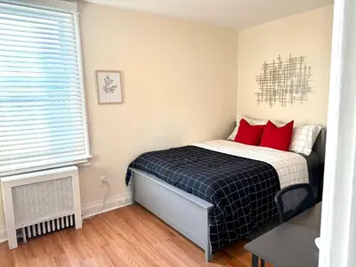 a small bedroom with a bed with red pillows at 9-A Diamond in Yonkers, NY in Yonkers