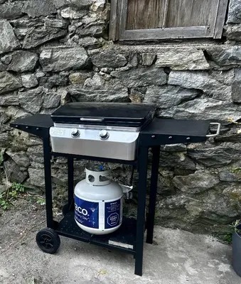 a stove with a pot on a cart next to a stone wall at 9-A Diamond in Yonkers, NY in Yonkers