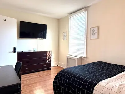 a bedroom with a bed and a flat screen tv at 9-A Diamond in Yonkers, NY in Yonkers