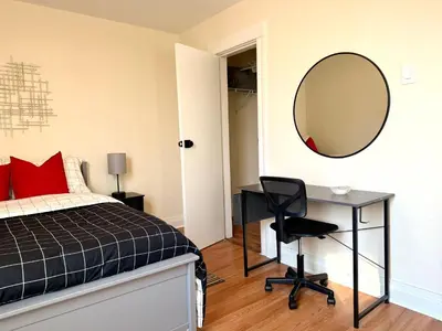 a bedroom with a bed and a desk and a mirror at 9-A Diamond in Yonkers, NY in Yonkers